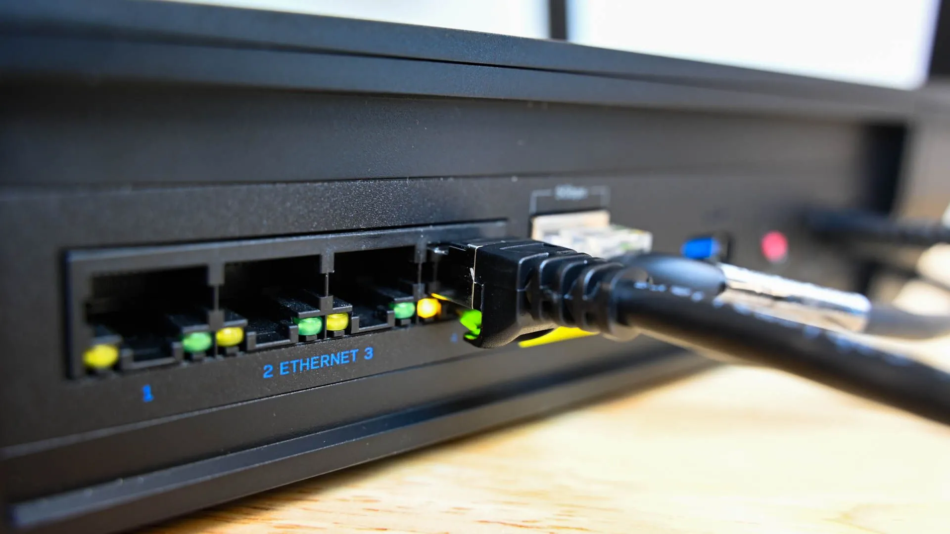 Các cổng Ethernet phía sau bộ định tuyến Wi-Fi gia đình, biểu tượng của kết nối mạng cục bộ (LAN) và khả năng giám sát lưu lượng truy cập internet.