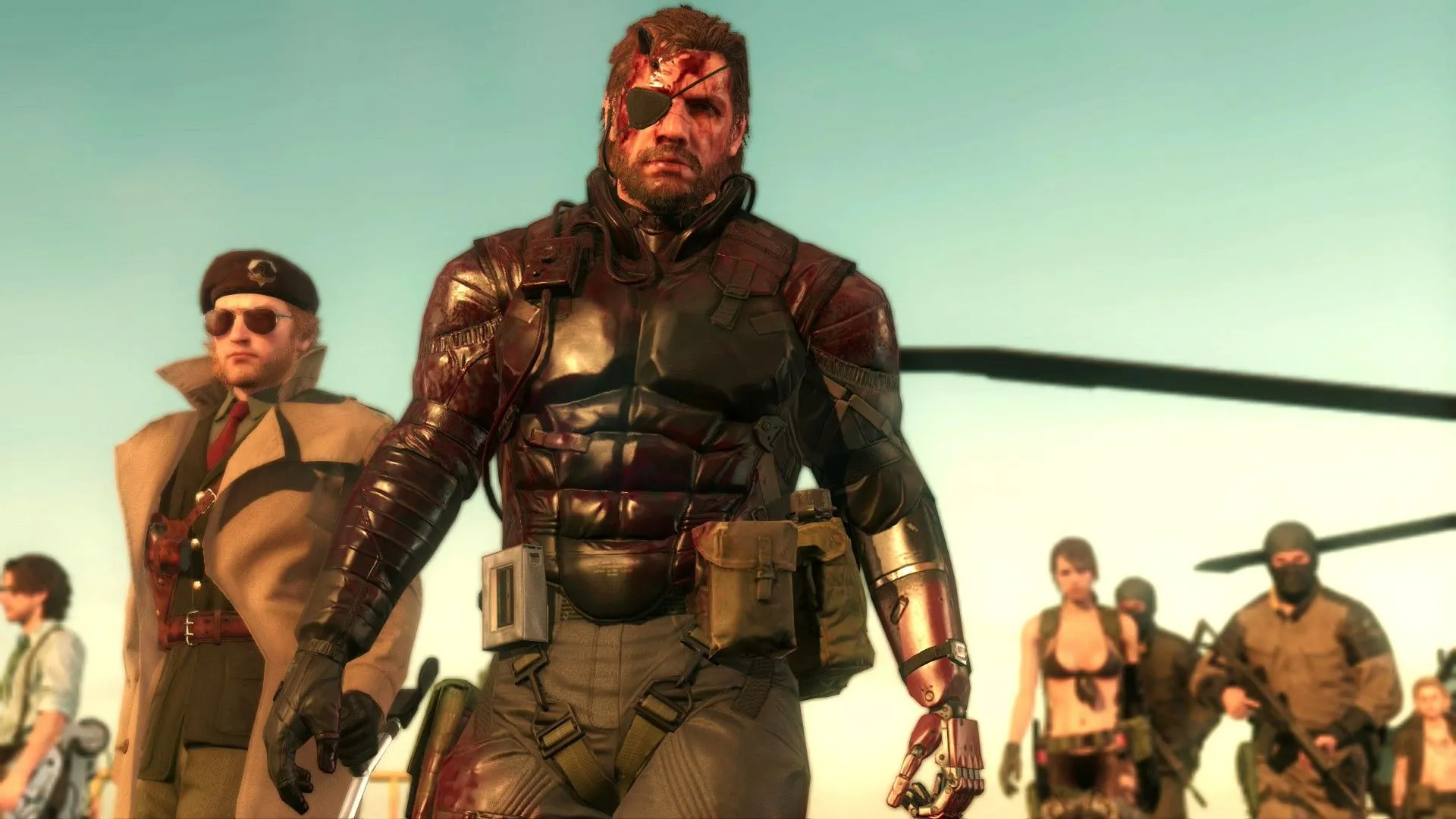 Các nhân vật Huey Emmerich, Kazuhira Miller, Venom Snake và Quiet cùng những người lính khác đang xem màn hình trong Metal Gear Solid V, thể hiện sự phức tạp của cốt truyện game)