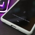 Điện thoại Google Pixel hiển thị tính năng Now Playing trên màn hình khóa cạnh bàn phím có đèn nền tím