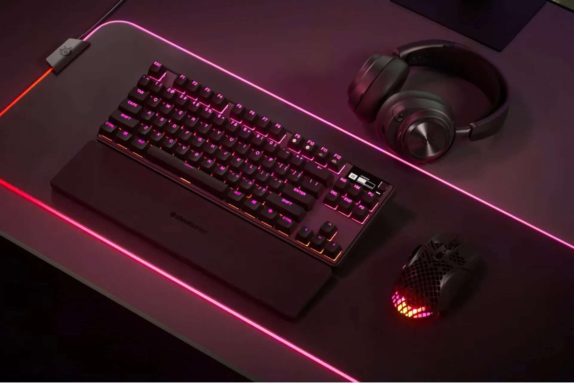 Bàn phím cơ SteelSeries Pro TKL và bàn di chuột lớn trên setup gaming, thể hiện không gian rộng rãi và tính thẩm mỹ
