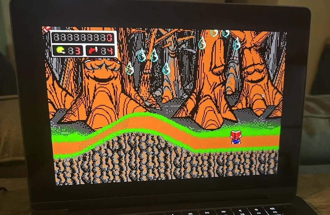 Game Commander Keen đang chạy trên máy MacBook Pro, hiển thị nhân vật chính và môi trường pixel art