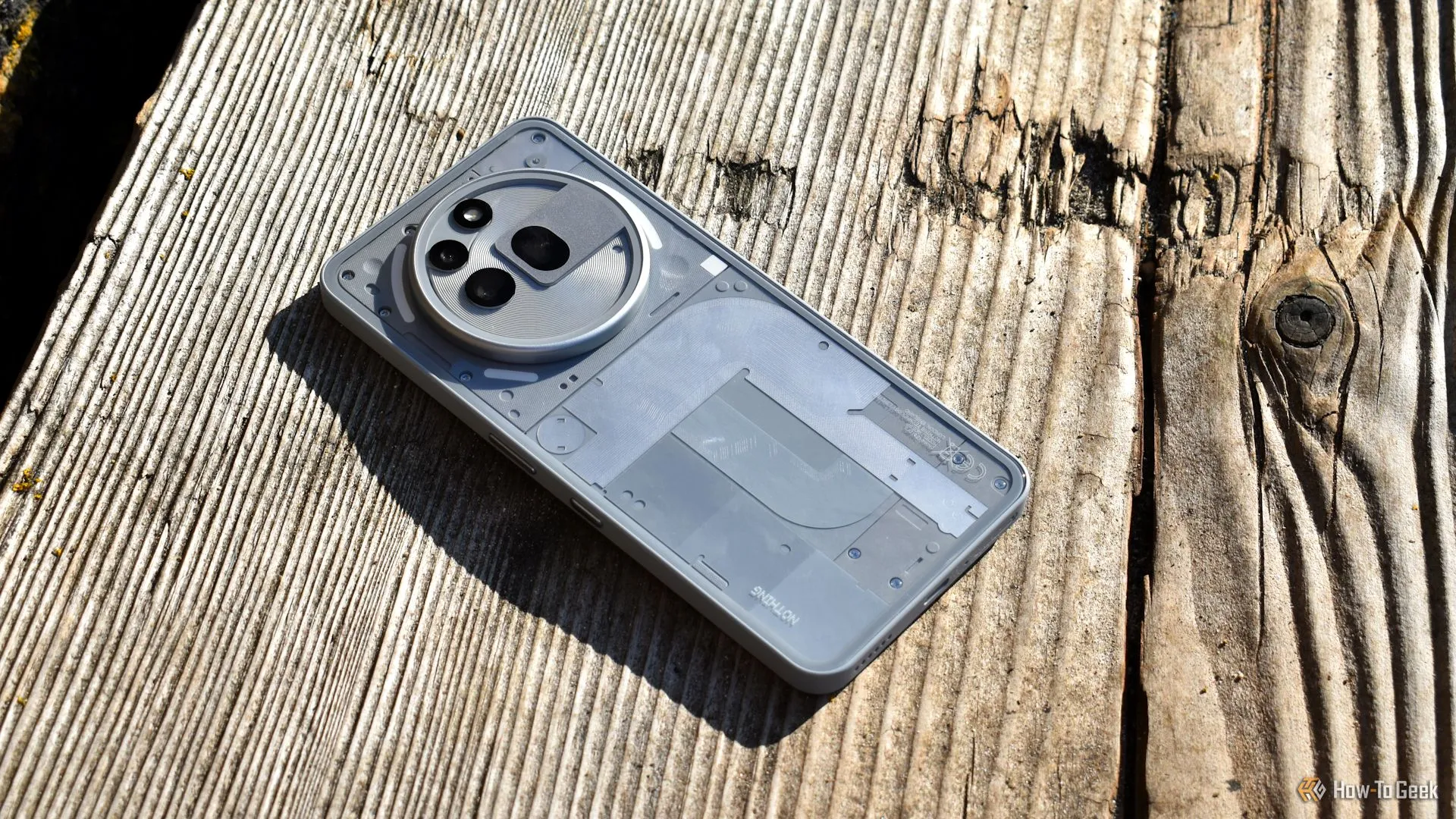 Góc nhìn từ trên xuống mặt sau của Nothing Phone (3a) Pro trong môi trường ngoài trời, nhấn mạnh thiết kế và vật liệu.