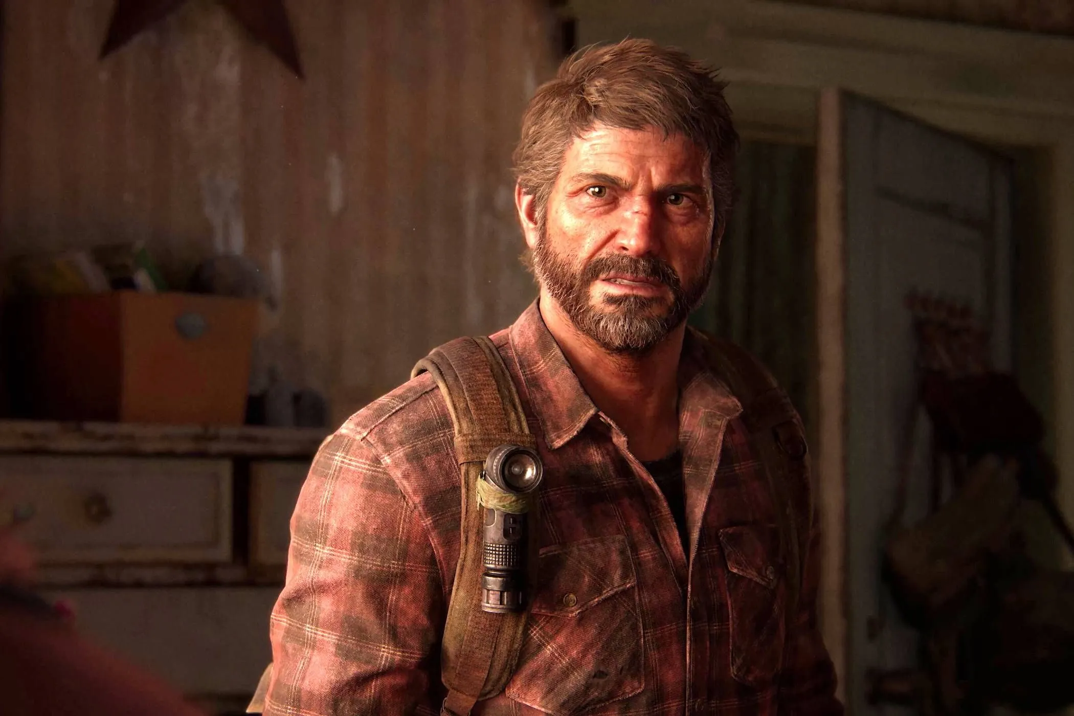Joel, nhân vật chính từ The Last of Us Part 1, trong một khoảnh khắc biểu cảm, đại diện cho trào lưu game remaster và remake đang chiếm ưu thế trên console thế hệ thứ 9.