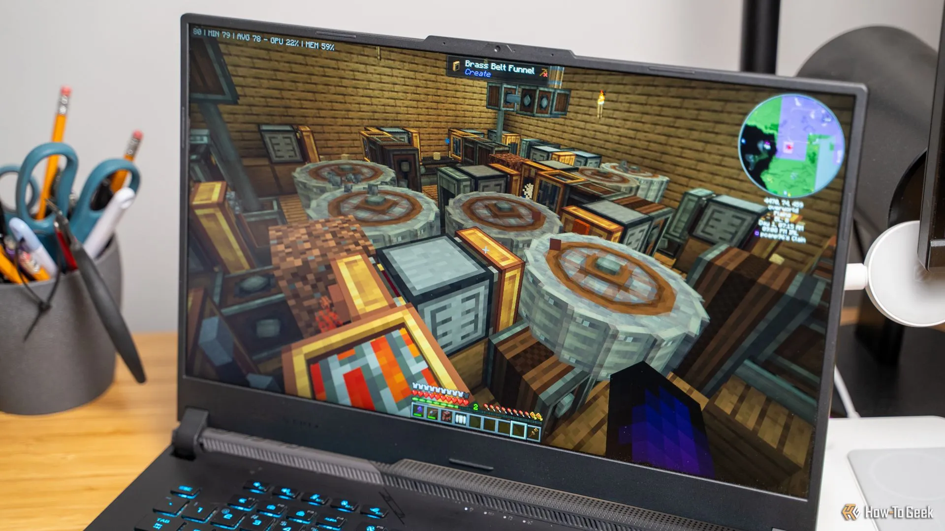 Một trang trại sắt tự động được xây dựng bằng Create Mod trong Minecraft, hiển thị trên màn hình laptop